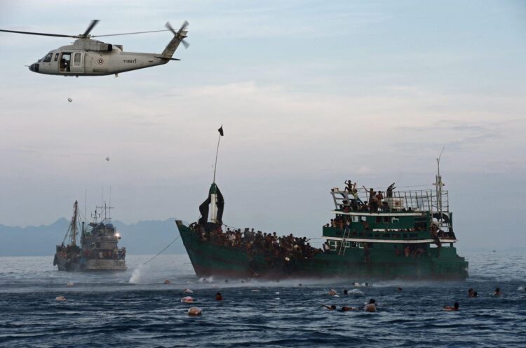 Food supplies dropped by a Thai army helicopter to boats of Rohingya refugees drifting in Thai waters off the southern island of Koh Lipe in the Andaman sea in May 2015 (Christophe Archambault/AFP via Getty Images)