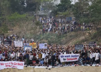 Rohingya refugees hold placards while attending a Ramadan Solidarity Iftar to have an Iftar meal with United Nations Secretary-General Antonio Guterres and Muhammad Yunus, Chief Adviser of Bangladesh Interim Government, at the Rohingya refugee camp in Cox's Bazar, Bangladesh, March 14, 2025. - Reuters